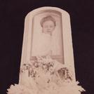 Woman in glass-topped coffin